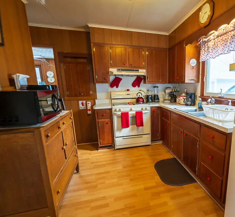 A kitchen with wooden floors and cabinets